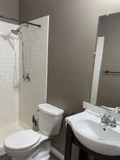 Bathroom with toilet and a tile shower