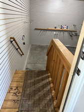 Stairs featuring wood walls