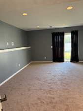 Empty room featuring recessed lighting, light carpet, and a textured ceiling