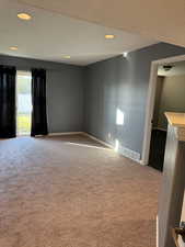 Spare room with light carpet and recessed lighting