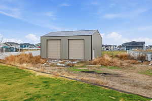 Detached garage featuring a residential view