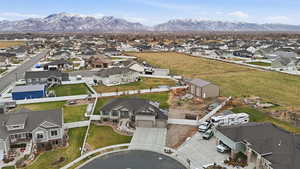 Aerial view of property's location with nearby suburban area and a mountain backdrop
