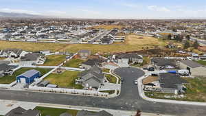 Aerial view of property and surrounding area with nearby suburban area