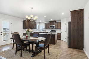 Dining space with light wood-type flooring and recessed lighting