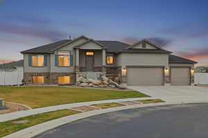 Craftsman-style house featuring stucco siding, concrete driveway, and an attached garage
