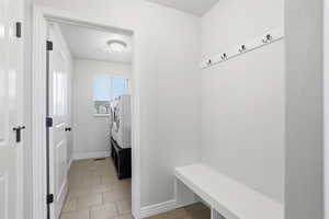 Mudroom featuring baseboards and light tile patterned flooring