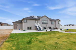 Back of house with a patio, a fire pit, a fenced backyard, and stucco siding