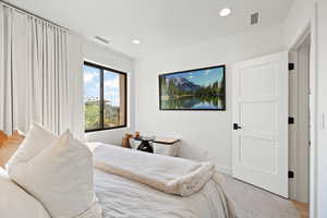 Carpeted bedroom featuring recessed lighting and baseboards