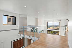 Hallway featuring healthy amount of natural light, recessed lighting, and wood finished floors