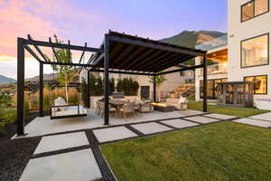 View of patio featuring a pergola, a mountain view, area for grilling, and an outdoor living space with a fire pit