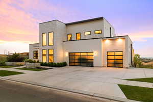 Contemporary home with driveway and stucco siding