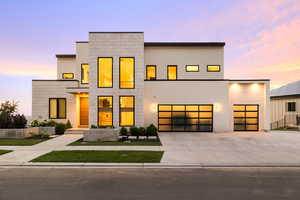 Modern home with driveway, stucco siding, and a garage