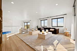Living area featuring light wood-style floors and recessed lighting