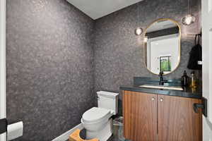 Half bath with vanity and toilet