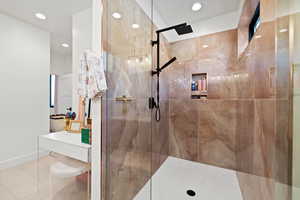 Bathroom with recessed lighting, a marble finish shower, and tile patterned floors