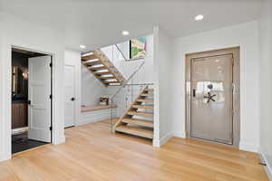 Foyer featuring recessed lighting, stairs, and light wood finished floors