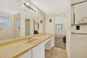 Bathroom featuring a vanity, a stall shower, and light floors