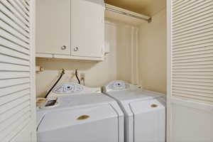 Laundry area with washer and dryer and cabinet space