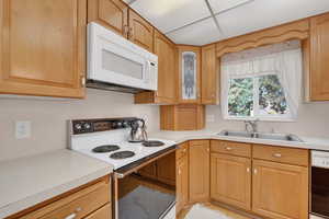Kitchen featuring white appliances and light countertops