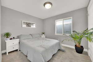 Bedroom with light colored carpet