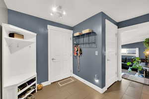 Mudroom with tile patterned floors