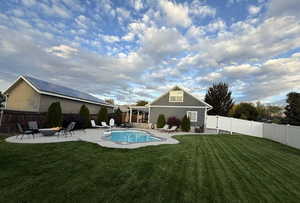 Back of property featuring a patio and a fenced backyard