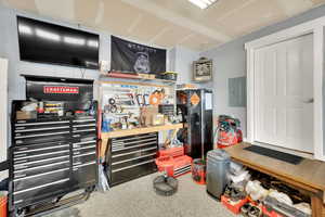 Miscellaneous room featuring a workshop area and electric panel