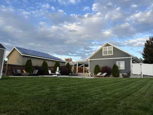 Rear view of property featuring a fenced backyard, a patio area, and a gate