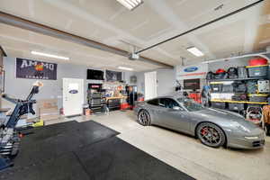 Garage with a workshop area and a garage door opener