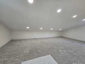 Bonus room with recessed lighting and carpet flooring
