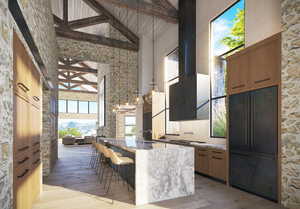 Kitchen featuring a breakfast bar area, a spacious island, paneled built in refrigerator, high vaulted ceiling, and light stone counters