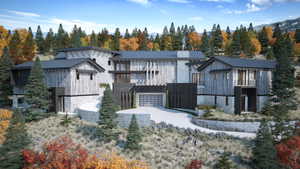 View of front of property featuring stone siding, a metal roof, and a view of trees