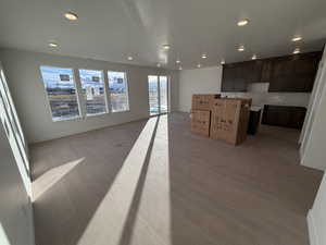 Unfurnished living room featuring light wood-style flooring and recessed lighting