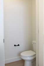Bathroom featuring baseboards and light wood-type flooring