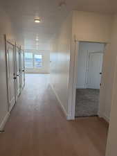 Hall featuring light wood-type flooring