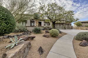 View of front of home featuring driveway, stucco siding, and a garage