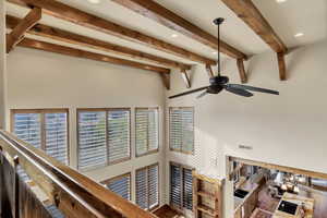 Detailed view of recessed lighting, beam ceiling, and ceiling fan