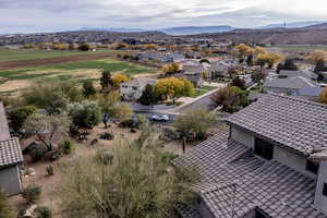 Aerial perspective of suburban area featuring a mountain backdrop