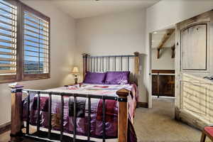 Carpeted bedroom featuring baseboards