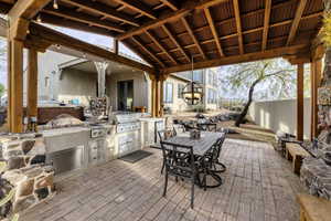 View of patio featuring area for grilling and outdoor dining space
