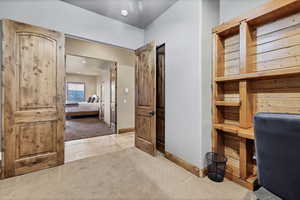 Tiled office space with carpet and baseboards
