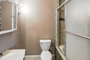 Full bathroom with tile patterned floors, vanity, and tiled shower / bath combo