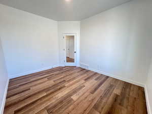 Spare room with hardwood / wood-style flooring and a textured ceiling
