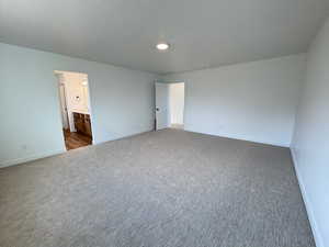 Unfurnished bedroom featuring carpet floors and connected bathroom