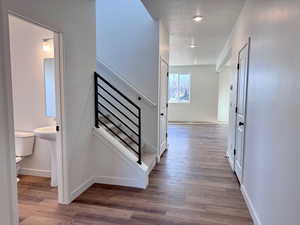 Stairs featuring hardwood / wood-style floors and a textured ceiling