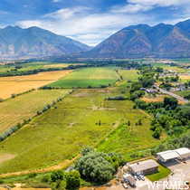View of mountain backdrop featuring rural landscape