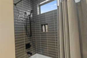 Full bathroom with shower / bath combination with curtain