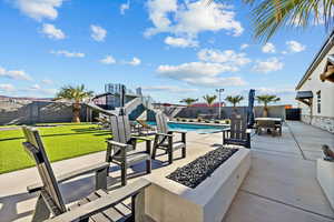 Fenced backyard with a fire pit and a patio area