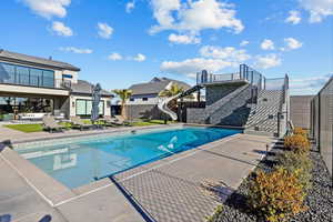 Outdoor pool with a water slide and a patio area