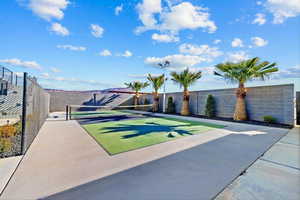 Surrounding community featuring a tennis court